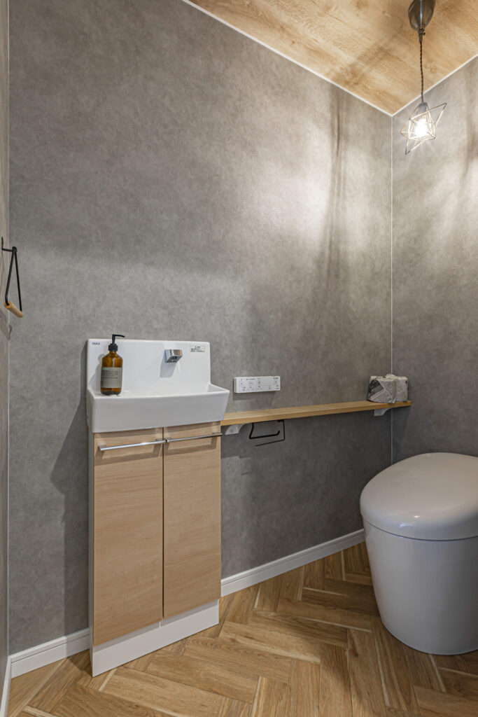 TOTOのタンクレストイレと手洗い器を付けた、長居したくなる落ち着きのあるトイレになります。